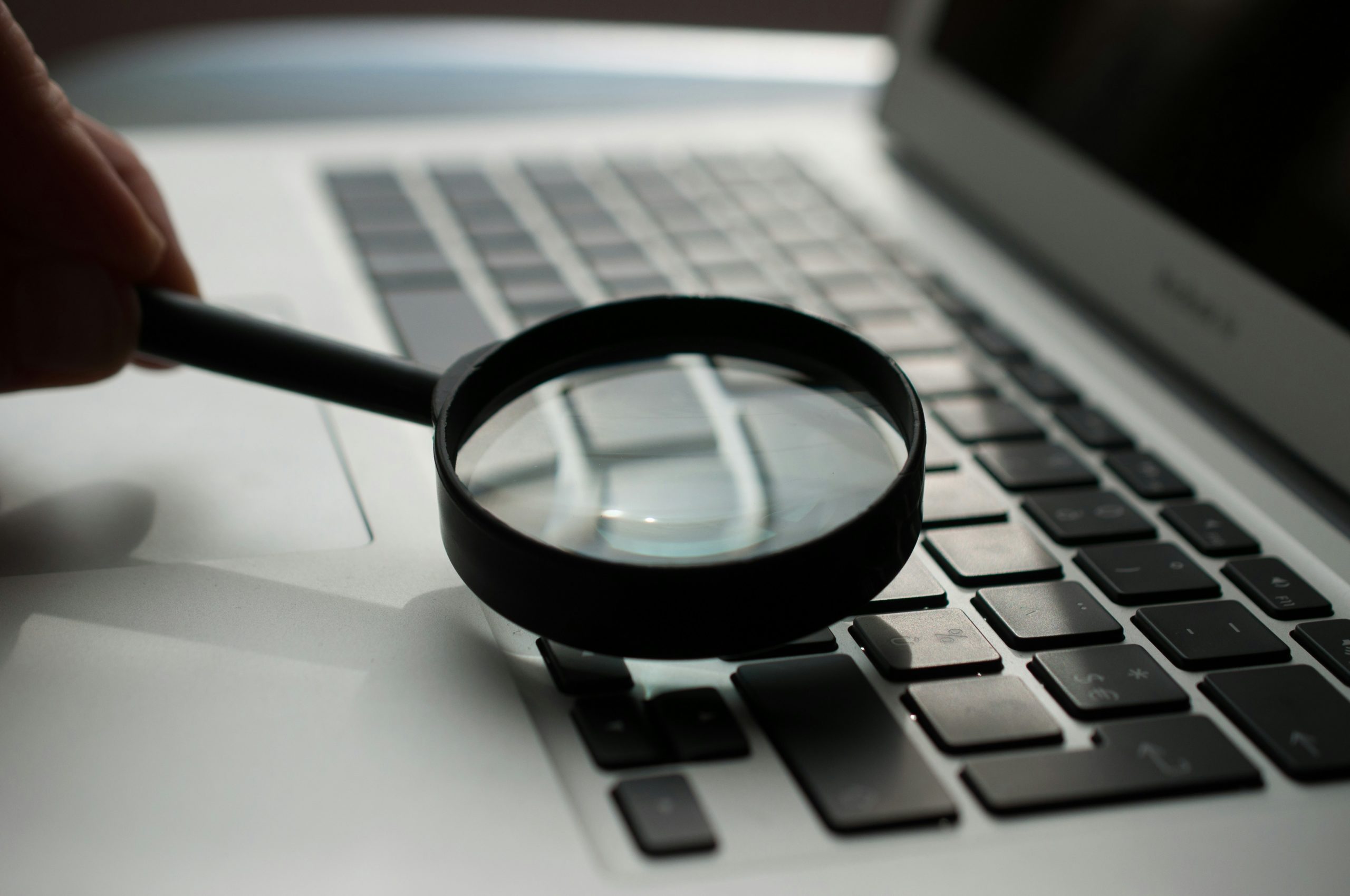 Magnifying glass over a laptop keyboard