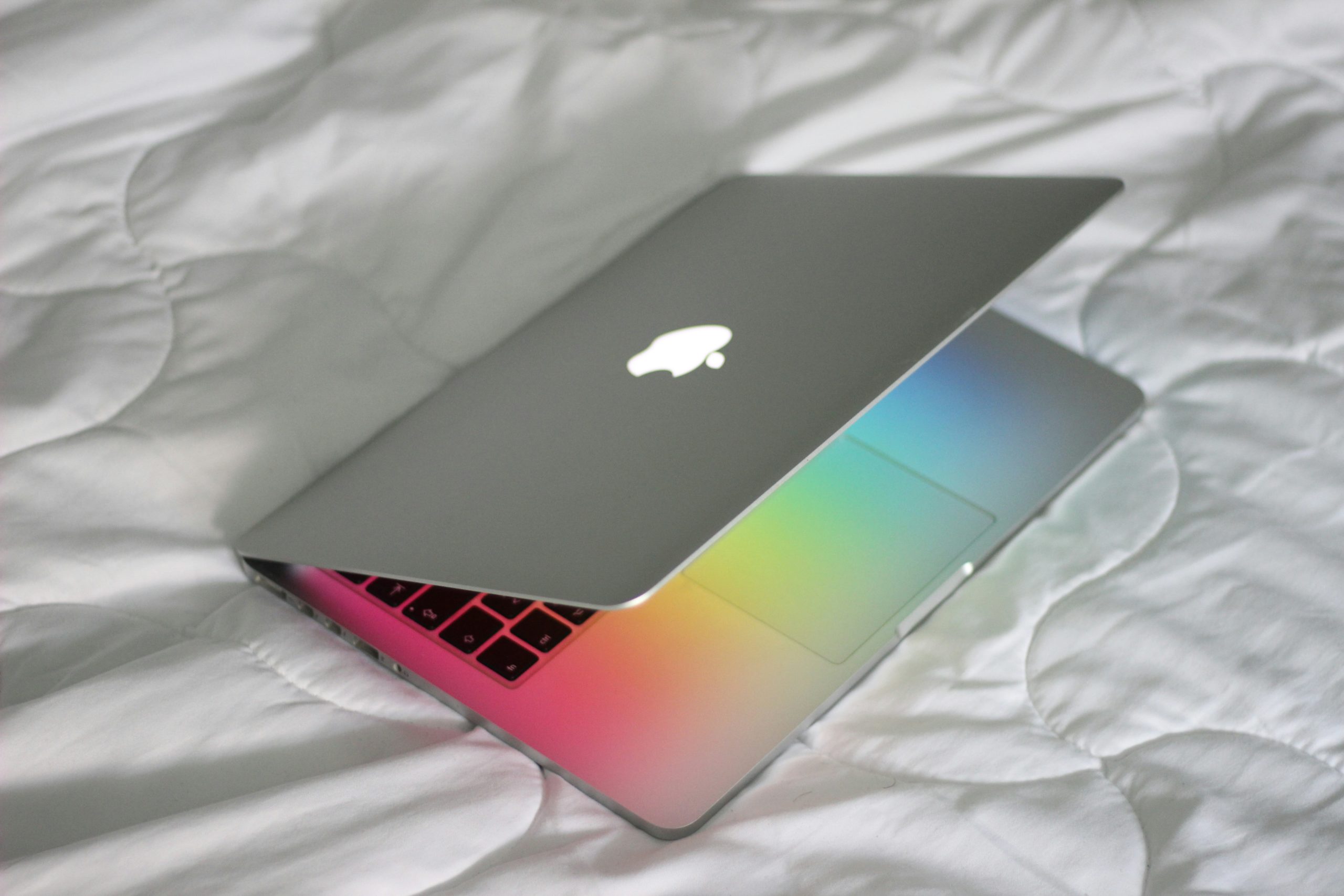 open laptop on a bed